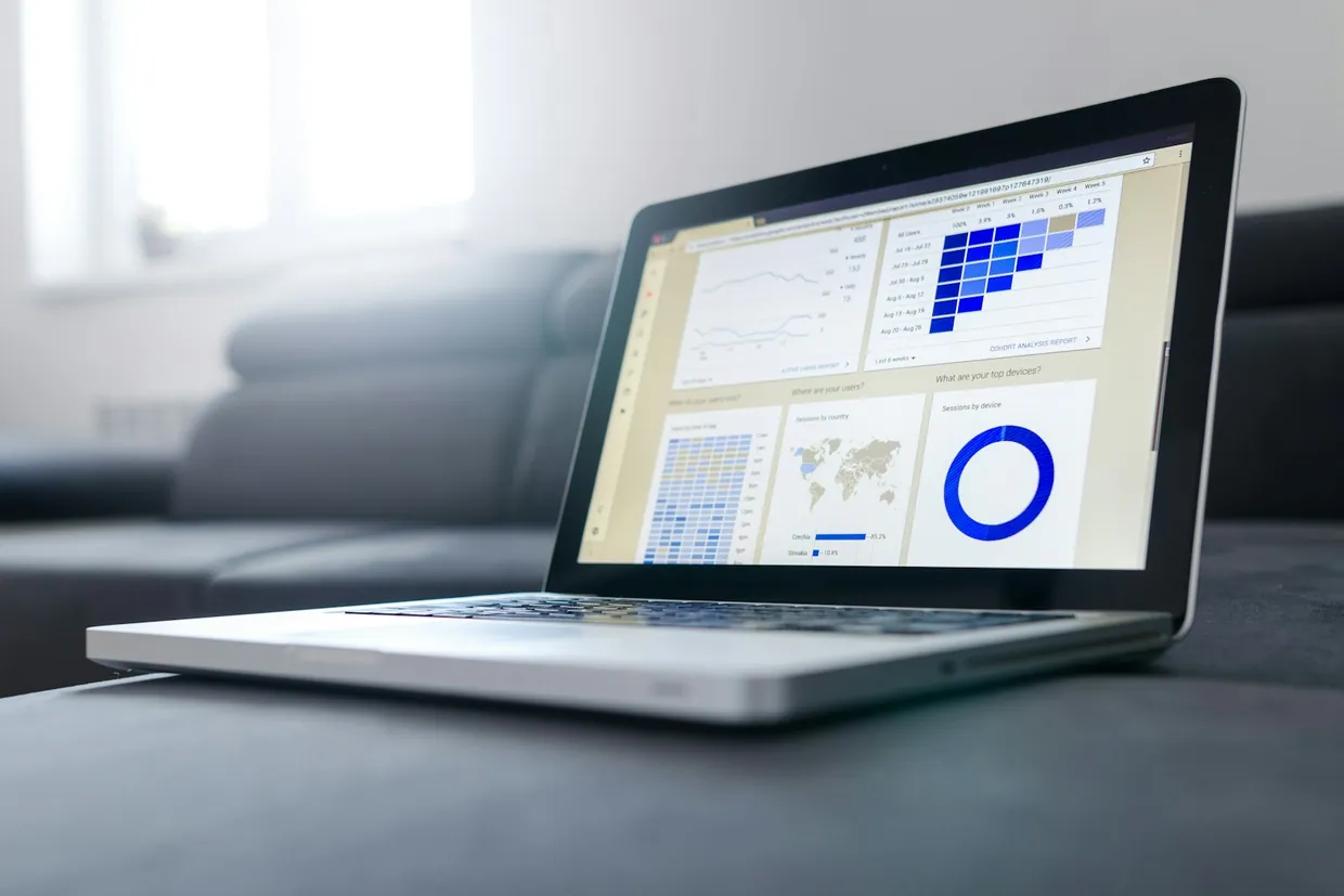 Laptop showing a report dashboard of charts and tables, the kind of report clean data feeds