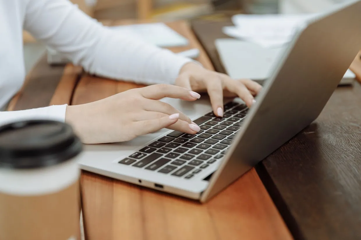 Hands typing a short first message on a laptop after a LinkedIn connection request is accepted