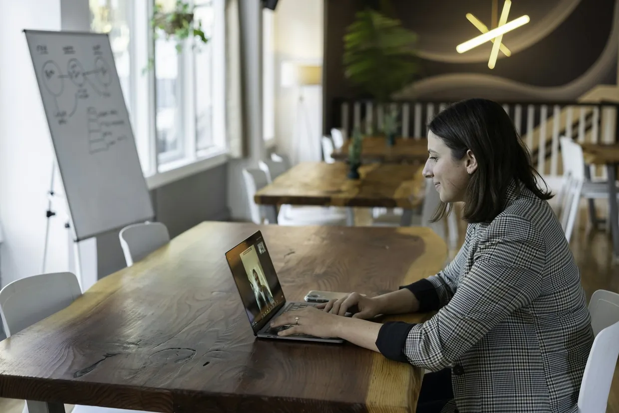 Interviewing a virtual assistant candidate on a video call from a bright shared workspace