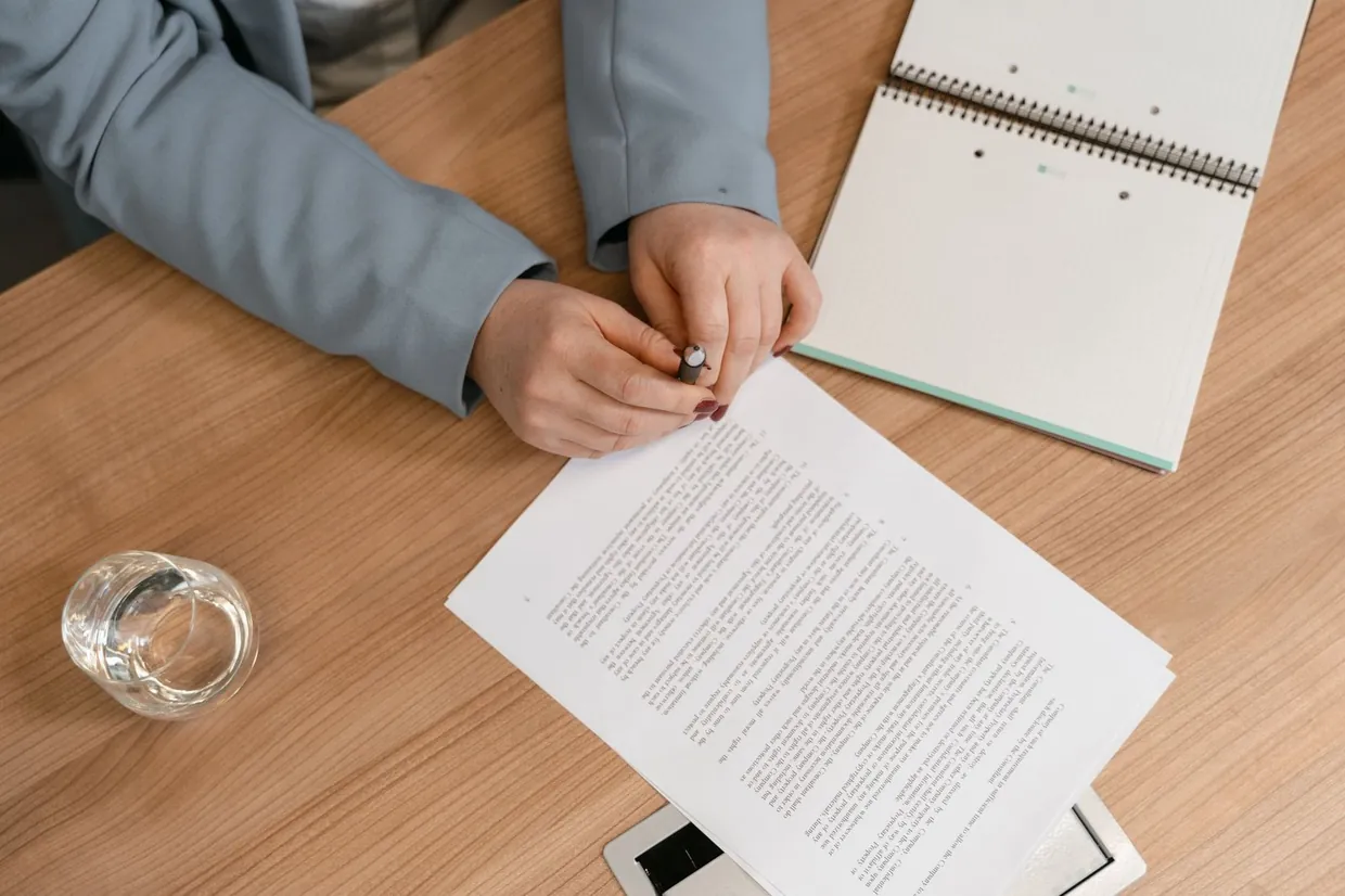 Reading through printed terms side by side to compare freelancer, agency and managed VA options