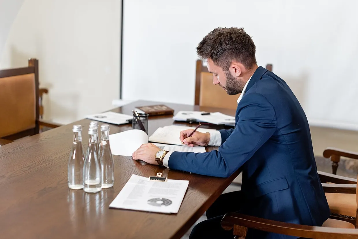 Working through a contract template at a meeting table before deciding whether to take legal advice