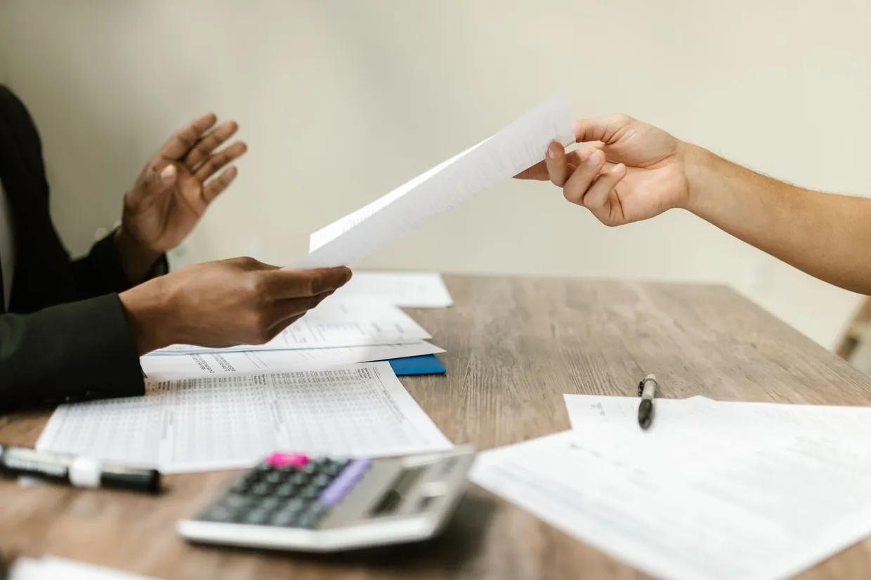 Passing a written summary across the desk to the colleague who will lead the next sales call