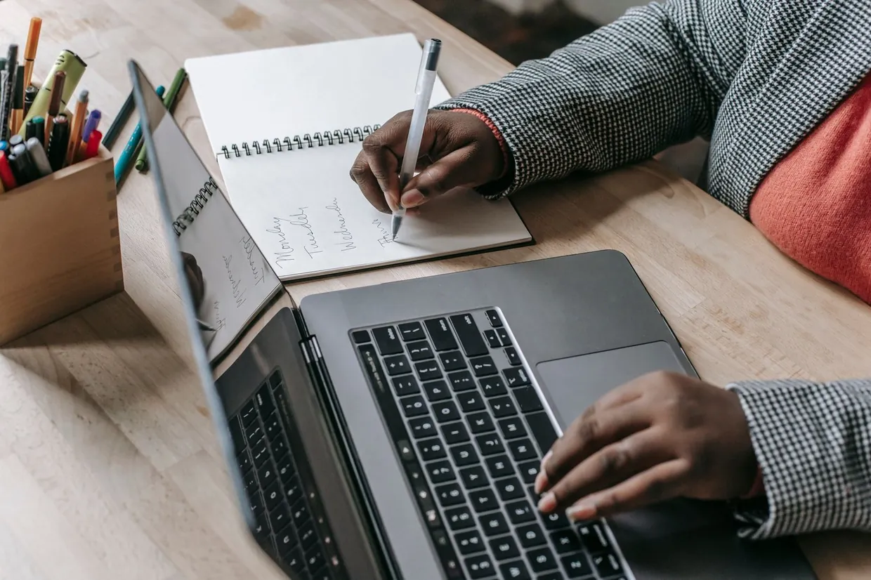 Entering records on a laptop while following written data entry rules in a notebook