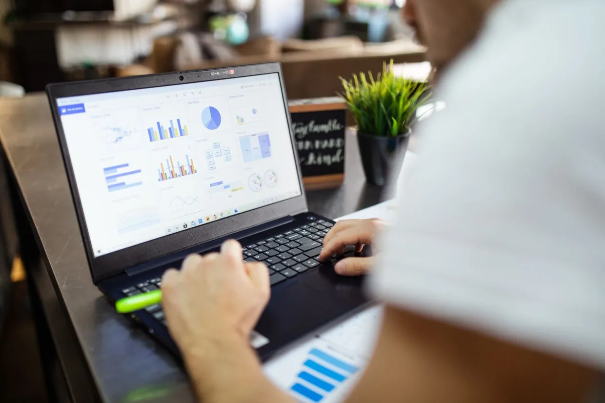 Reviewing a weekly results dashboard on a laptop to measure lead generation by channel